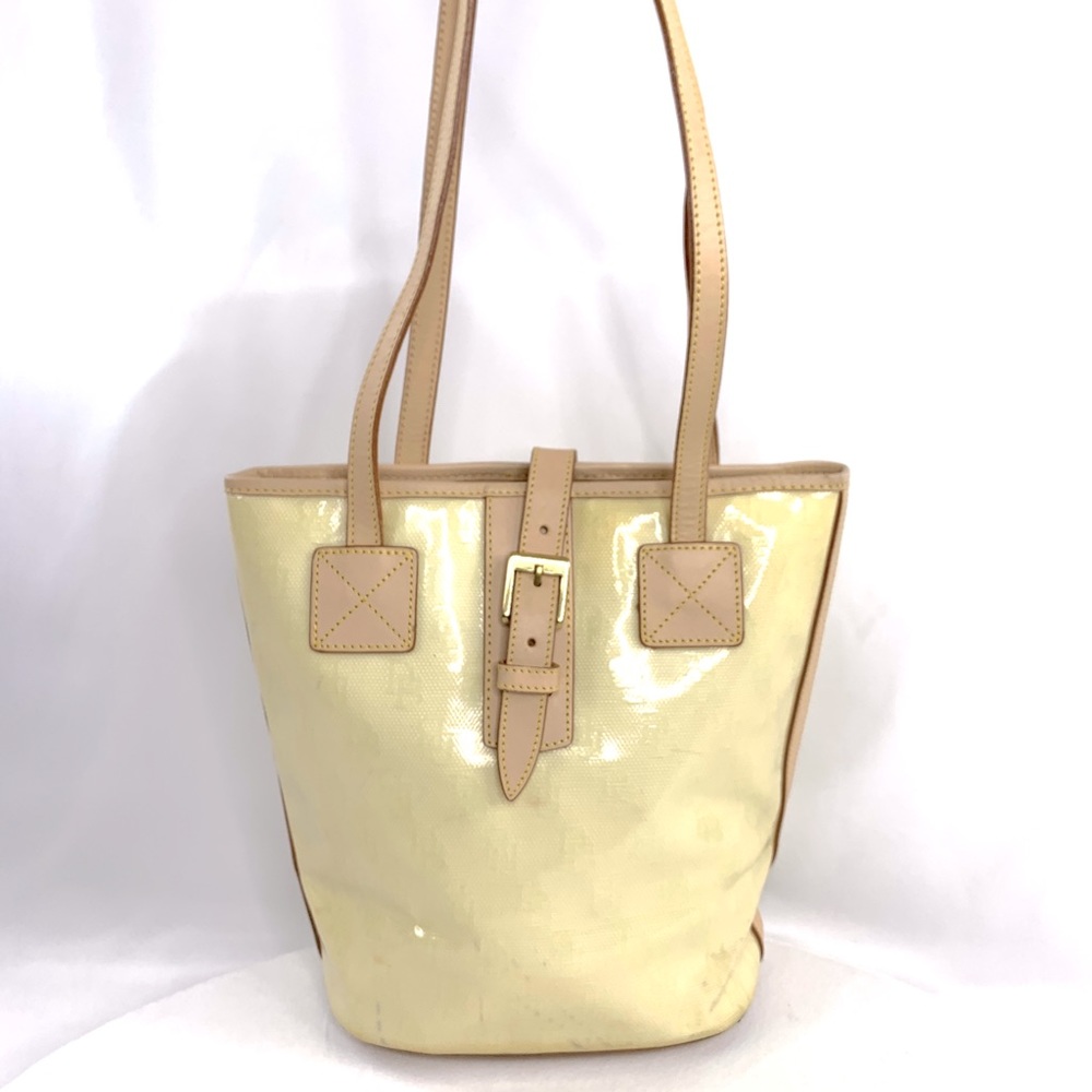 Dooney Bourke Cream Yellow Signature Embossed Coated Cotton Bucket Shoulder Bag